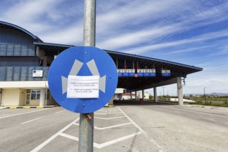 Notice on traffic sign informing travellers, deserted border crossing Niki Medžitlija to North