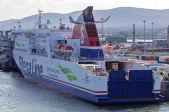 Large ferry in the harbour ready for loading or unloading surrounded by industrial plants, Belfast