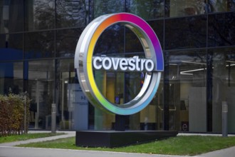 Covestro AG, company logo in front of the corporate headquarters at dusk, Leverkusen, Bergisches