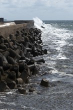 Storm on the offshore island of Heligoland, waves lashing against the western breakwater, tetrapods