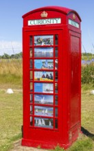 Red K6 telephone box repurposed as local curiosity information booth, Felixstowe Ferry, Suffolk,