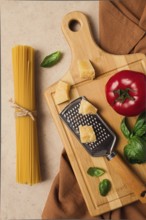 Raw pasta with ingredients on a beige background, top view, rustic style, selective focus, no