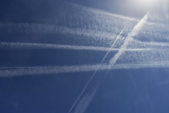 Condensation trails in the blue sky, Bavaria, Germany, Europe