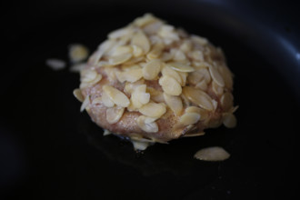 Swabian cuisine, meatballs wrapped in almonds, mixed minced meat, raw, frying meatballs in fat,