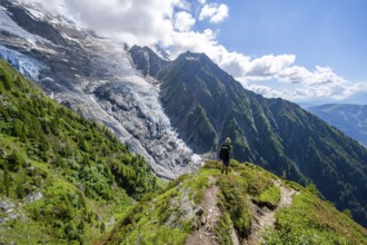 Mountaineer in front of impressive mountain landscape with glacier, view of glacier Glacier de