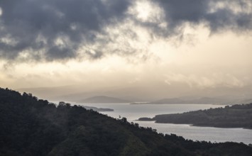 View to the sea over wooded hills, at sunset, cloud forest, Monte Verde, Puntarenas province, Costa