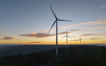 Wind turbines form a silhouette against a dramatic sunrise, wind farm, Rems Valley,