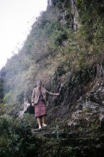 Female tourist descending the steep mountain path Huayna Picchu, Machu Picchu, Peru, South America