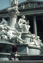 Young woman standing by statue of Pallas Athene, Vienna, Austria, early 1960s, Europe