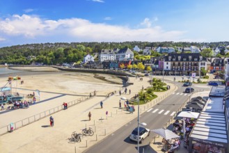 Aerial view at the boardwalk and city street with walking people and cars in Morgat, a coast