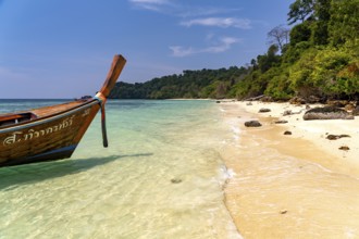 Long-tail boat on the dream beach of Ao-niang on the island of Koh Kradan in the Andaman Sea, voted