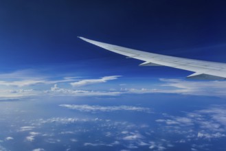 View from the aircraft window during a flight over India with the airline Etihad. Blue sky and