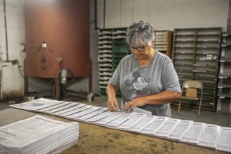 Liberal, Kansas, Lisa Diaz puts mailing labels on copies of the Kiowa County (Colorado) Independent