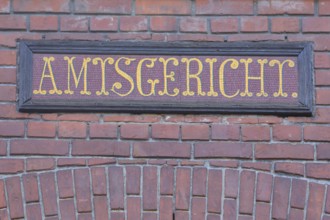 Local court in the historic town hall, red brick building, yellow inscription, detail, red, yellow,