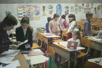 Pupils in a classroom in one of the metro schools in Kharkiv. Classrooms were set up in various