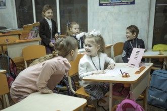 Pupils in a classroom in one of the metro schools in Kharkiv. Classrooms were set up in various