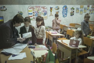 Pupils in a classroom in one of the metro schools in Kharkiv. Classrooms were set up in various