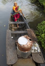 Tealady, 83 years old, paddling in her boat through the backwaters, Kumarakom, Kerala, India, Asia