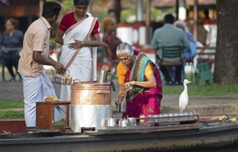 Tealady, 83 years old, making Indian tea on her boat, Backwaters, Kumarakom, Kerala, India, Asia