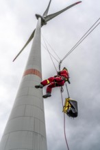 Height rescuers from the Oberhausen fire brigade practise abseiling from a wind turbine from a