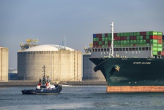 LNG import terminal tanks for liquefied natural gas in the seaport of Rotterdam, harbour tug brings