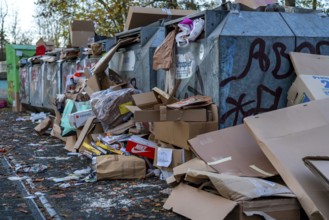 Overfilled waste paper containers, despite the overcrowding, people have put their waste paper next