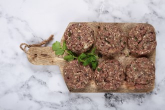 Raw cutlets, minced meat, on a chopping board, homemade, top view, no people