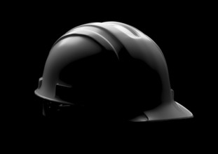 Dramatically lit hard hat isolated on a black background