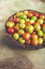 Cherry plum tkemali, fruit, plum variety, in a wooden plate, Georgian cuisine, top view, no people