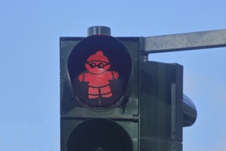 Red pedestrian traffic light with Mainzelmännchen as symbol for standing, waiting, stopping, halt,