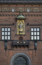 Brick façade with gilded sculpture of Bishop Absalon, St City Hall in the National Romantic style