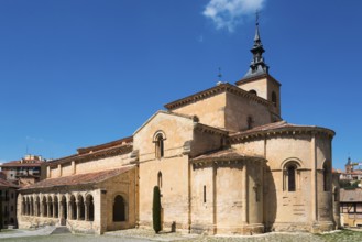 Historic church with stone arches and a Gothic tower under a blue sky, Church of San Millan,