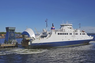 A large ferry docks in the harbour under a blue sky, electric ferry, Horten, Oslofjord, Norway,