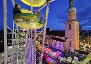 In the Ferris wheel at the Christmas market with the Reinoldikrche in the evening, Dortmund, Ruhr