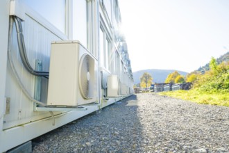 Side view of containers with air conditioning, in the background nature and sun, refugee