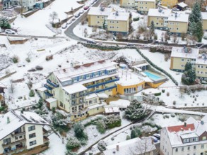 Aerial view of a snowy town with colourful houses and mountainous terrain, Bad Wildbad, Black