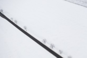 Aerial view of a straight country road in the snow, near Oederan, Saxony, Germany, Europe