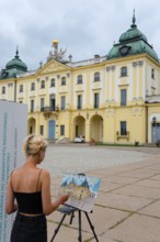 Artist paints in front of a baroque palace, harmonises with the architectural backdrop, Branicki