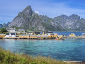 Sakrisøy fishing village, yellow fishermans cabins at the sea on small island Sakrisøy, near