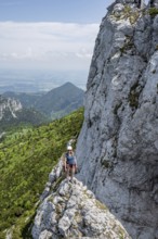 Climber with climbing rope on a climbing tour, climber on a mountain ridge, alpine climbing,