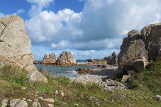 Coastal landscape with rocks, sea view and grassy paths under a cloudy sky, Plage de Pors Scaff,