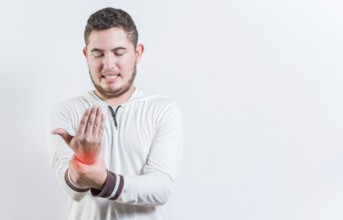 Person with arthritis pain rubbing hand isolated. Suffering young man with pain in hand joints