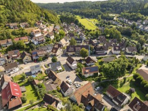 A picturesque village with many houses, nestled in a green, hilly landscape, Gundringen, Nagold,