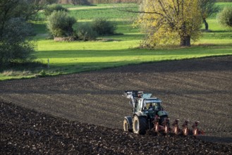 Farmer ploughing a field, tractor with plough, near Neuss, North Rhine-Westphalia, Germany, Europe