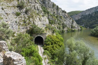 Permeable railway tunnel next to a river, surrounded by a rocky landscape, River Nestos or Mesta,