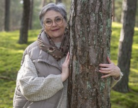 Portrait of elderly woman, 65 years old, enjoying nature in the forest in Ystad, Skåne, Sweden,