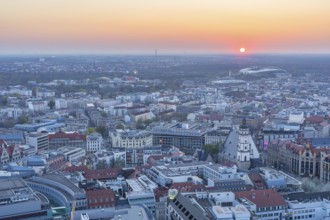 View of the city from the City Tower at sunset, St Thomas' Church, Red Bull Arena and Auwald