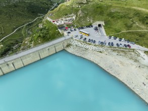 Dam of the Moiry lake, Lac de Moiry, turquoise glacial water, parking lot and restaurant at the