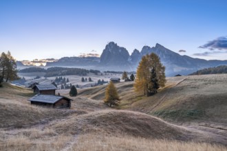 Autumn on the Seiser Alm, Alpine huts with Plattkofel and Langkofel, frost, fog, Dolomites, South