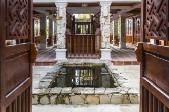 Interior of tropical hotel with a small pond